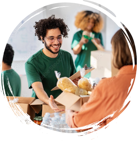 Man smiling holding a clipboard accepting a box of food