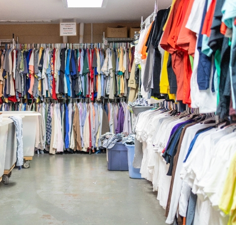 a room lined with different kinds of shirts hanging up