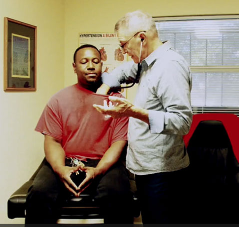 man receiving a checkup from a doctor