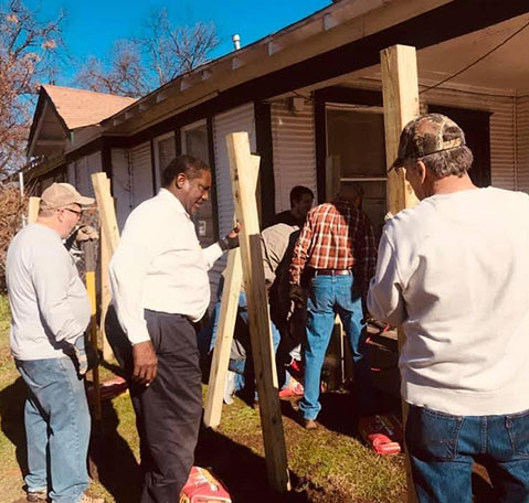 Shalom Builders of Texas carrying wood